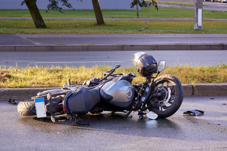 damaged motorbike on the city road at the scene of an accident
